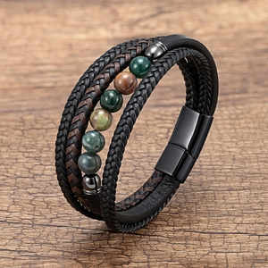 Detail of multilayer woven leather bracelet with stone beads and magnetic metal clasp