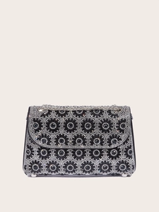 Macro shot of black evening bag with sunflower rhinestone patterns and silver chain strap