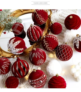 Detail of dark red flocked Christmas balls with gold threads and white pearl accents