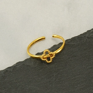 Adjustable golden stainless steel ring featuring a beaded four-leaf clover floral design