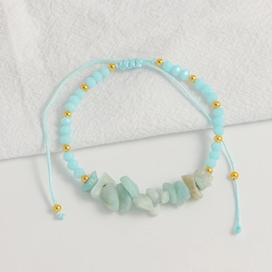 Close-up of light blue bohemian handmade woven bracelet with natural stones and beads