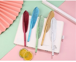 Top view of creative feather-shaped pens in 5 metallic colors on a colorful background