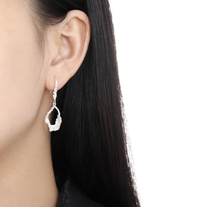 Irregular hollow teardrop earrings in S925 sterling silver with textured surface finish