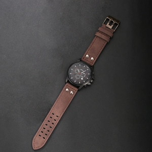 Vintage men's quartz watch with brown leather rivet strap and black frosted dial