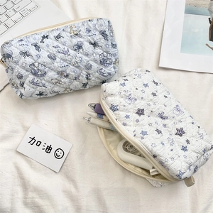 Detailed view of quilted cotton pouches featuring cute bear patterns and zipper closures