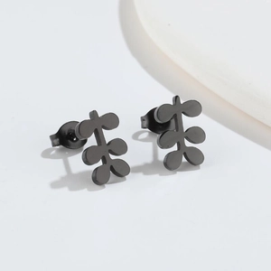 Macro view of matte black leaf-shaped stainless steel stud earrings with butterfly backs