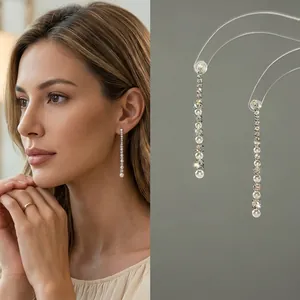 Detailed view of long tassel earrings with sparkling cubic zirconia and white pearls