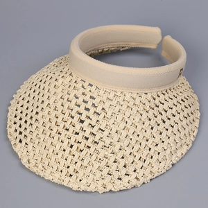 Detail of hand-woven hollow straw visor featuring a stylish embroidered letter R accent