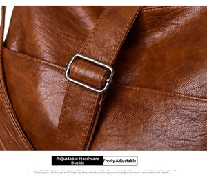 Close-up of brown PU leather texture with silver adjustable metal buckle on shoulder strap