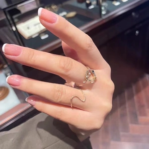 Gold wave band ring and crescent moon ring set with colorful stones on hand