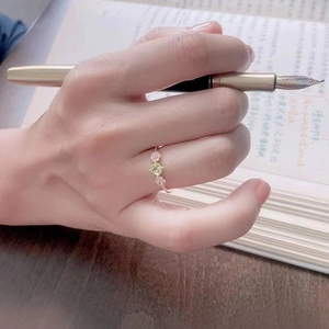 Exquisite rose gold ring featuring a square green gemstone and pink floral accents