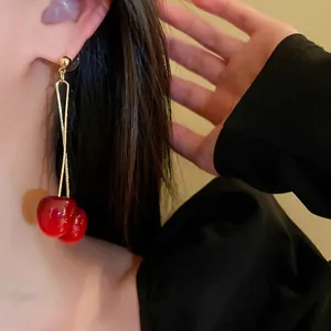 French style red cherry drop earrings with gold chain on model for elegant vintage look