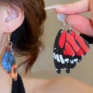 Exaggerated acrylic butterfly wing earrings with colorful patterns and metal hooks