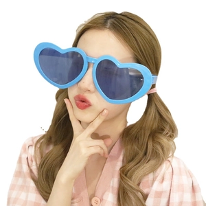 Oversized blue heart-shaped sunglasses with thick plastic frames and dark lenses