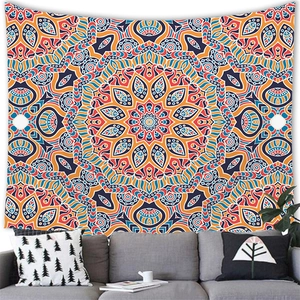 Detail of bohemian mandala tapestry with vibrant orange and blue patterns in a living room