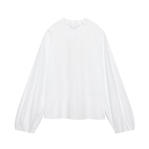 Detail shot of white poplin shirt featuring ruffled collar and elegant lantern sleeves