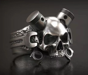 Detail of mechanical skull ring featuring dual pistons and wrench relief carvings
