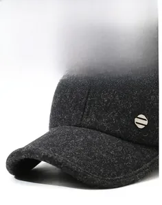 Detail of dark gray wool baseball cap featuring thick fiber texture and metal fashion tag