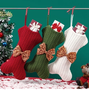 Detailed knitted bone-shaped Christmas stockings in red, green, and white with bows