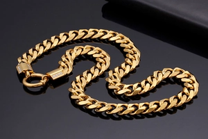 Macro detail of gold plated cuban link chain featuring a sparkling diamond encrusted clasp