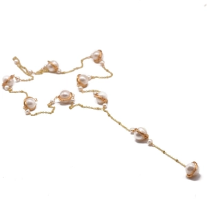 Elegant natural freshwater pearl necklace with gold wire wrapping on a white background