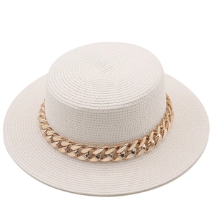 Detail of flat top boater straw hat featuring a thick gold metal chain decoration