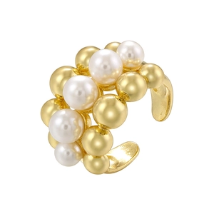 Golden beads and faux pearls stacked ear cuff earring on a clean white background