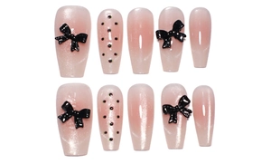 Pink gradient long trapezoid nails with 3D black bows and glitter accents