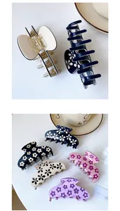 Detail of floral acetate shark hair clips with strong metal springs in multiple colors