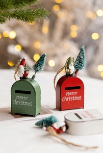 Three festive metal Christmas mailbox ornaments with resin figures and snowy pine trees