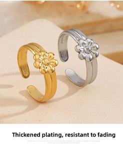 Detailed view of two 18K gold and silver plated floral adjustable rings on stone background