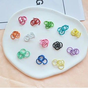 Colorful lacquered metal open jump rings in various vibrant shades for DIY crafts