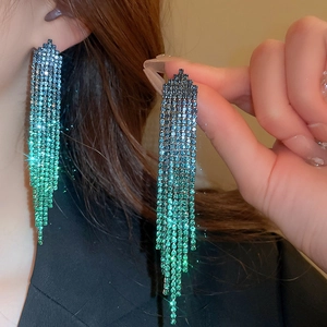 Close-up of sparkling colorful gradient rhinestone fringe earrings with silver needle studs
