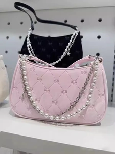 Pink quilted shoulder bag with bow details and elegant pearl chain handle