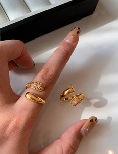 Detail of gold-plated wrap ring with multicolor zircon stones and sleek polished finish