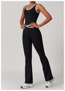 Detailed view of the contrast trim on black yoga vest and flared leggings gym set