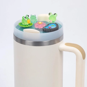 Detail of 40oz tumbler lid featuring a miniature frog pond with lotus and lily pads