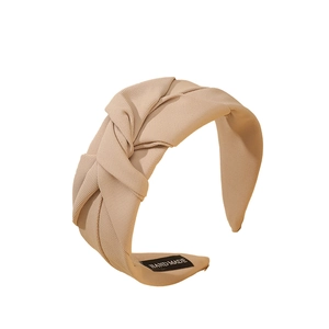 Elegant beige wide knotted headband with textured fabric shown on a white background