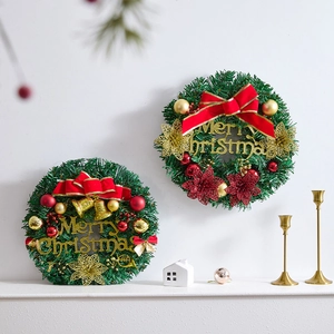 Elegant artificial Christmas wreaths with gold Merry Christmas sign and red bows