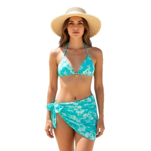 Three-piece bikini set with light blue floral print, halter top and matching sarong skirt