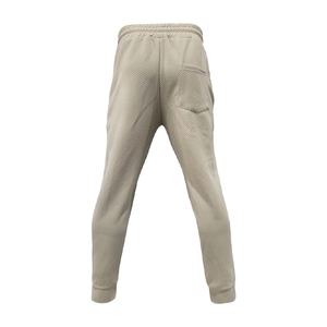 Rear view of beige twill texture jogger pants with elastic waist and back pocket detail