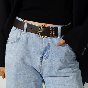 Women's dark brown leather belt with gold bamboo buckle paired with jeans and blazer
