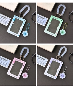 Detail of four acrylic photocard holders with clover glitter and spring coil lanyards
