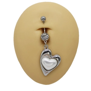 Polished heart belly button ring with white inlay and clear cubic zirconia on a model