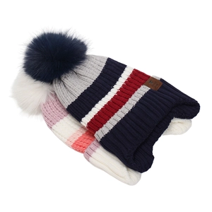 Detail of striped knit beanies featuring large faux fur pom-poms and soft ribbed texture