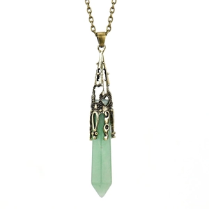 Detail of vintage bronze hollow cap on a green hexagonal natural stone crystal pendant