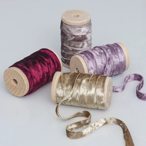 Rolls of 1cm double-sided velvet ribbon in assorted colors on wooden spools