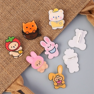 Cute Korean acrylic animal pins featuring cartoon bears and cats on a burlap bag