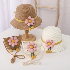 Cute straw hat and bag set for kids with floral trim and decorative pom poms