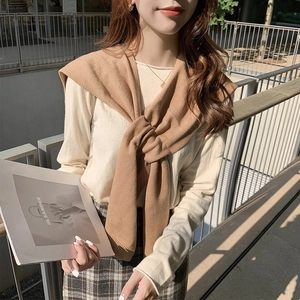 Knitted camel shoulder wrap shawl tied over a white top for a stylish autumn look